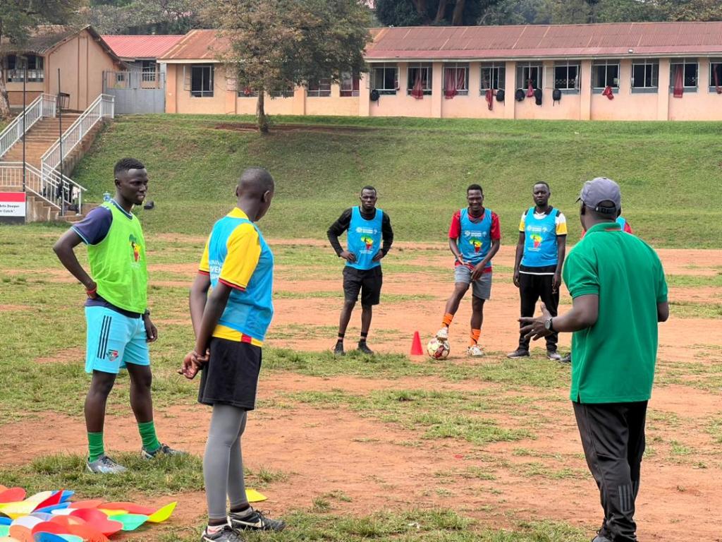 cate in yellow and blue bib listening in to the instructor in training session.